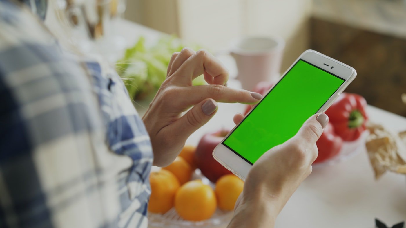 Person using a smartphone at home to organize daily plans